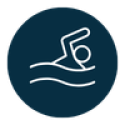 Navy circle with white outline icon of person swimming in water. 