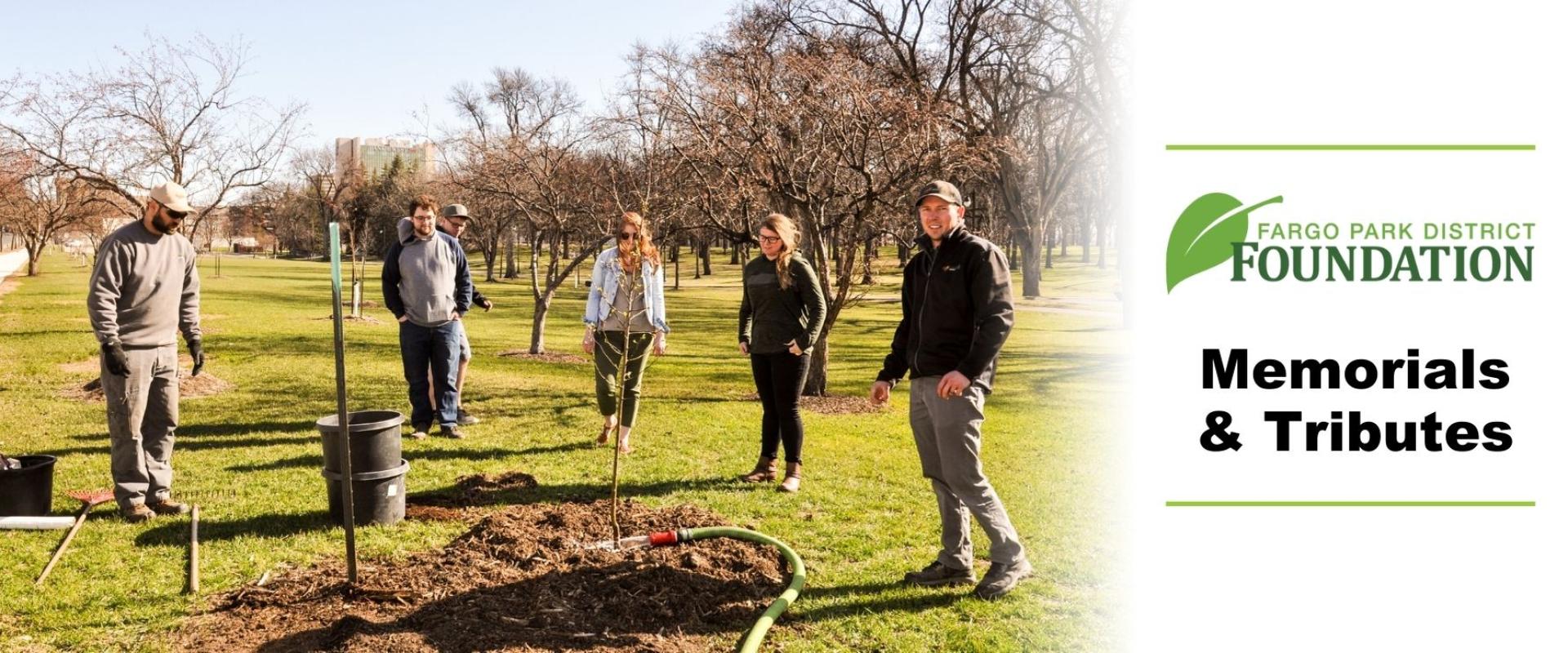 This photo shows a group planting a tree at Island Park