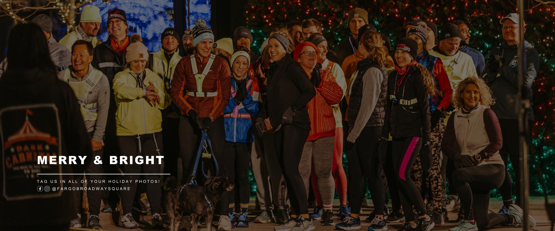 This graphic shows people taking photos at the square with text that says merry and bright