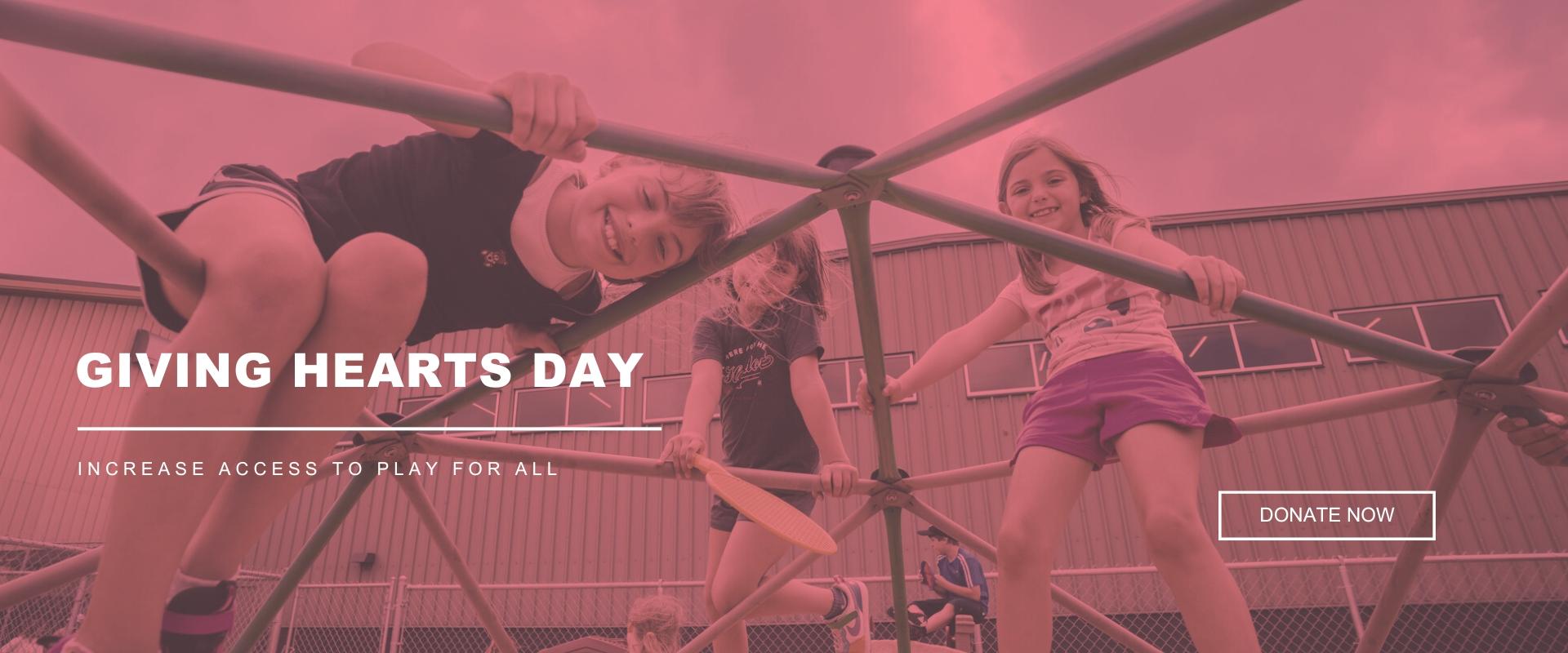 Children smiling and climbing on a playground structure with text reading ‘Giving Hearts Day: Increase access to play for all.