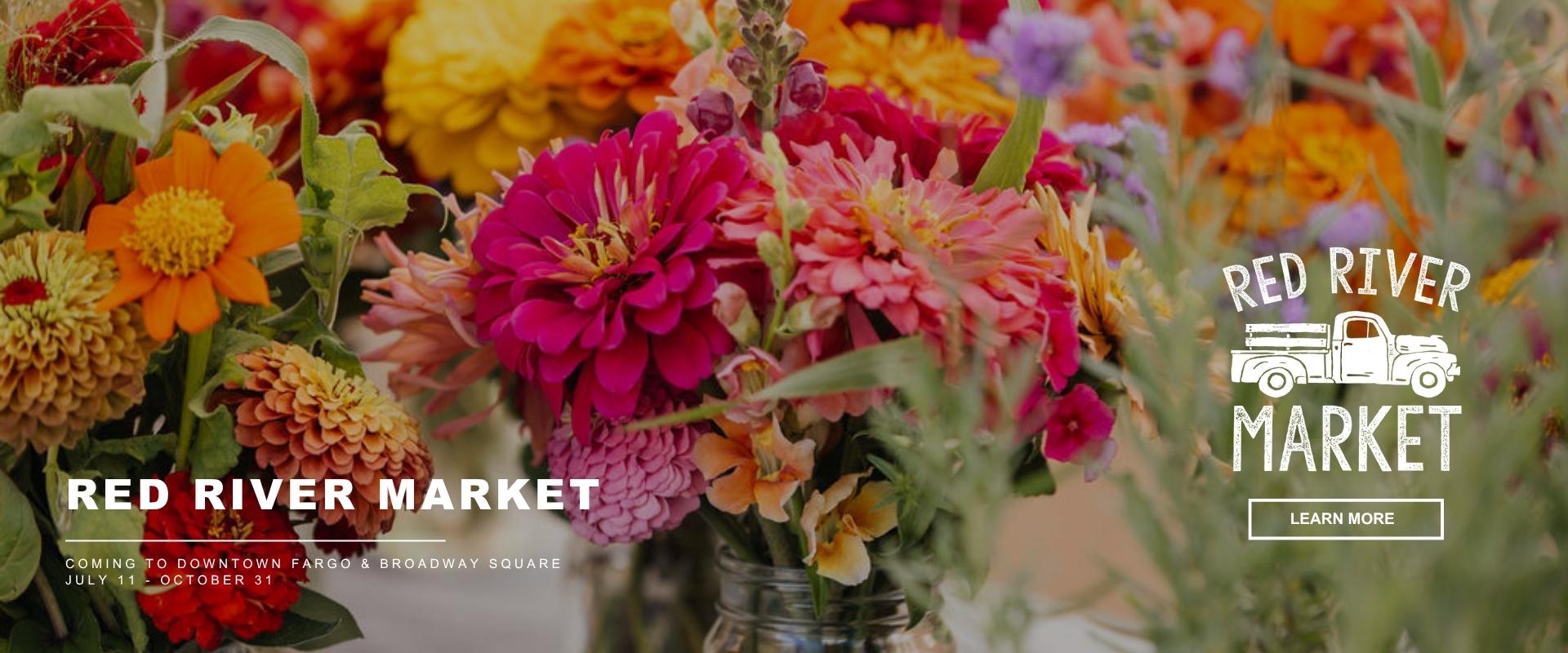 Promotional graphic for the Red River Market featuring colorful flower bouquets. Text reads “Red River Market,” “Coming to Downtown Fargo & Broadway Square,” and “July 11 – October 31,” with a “Learn More” button