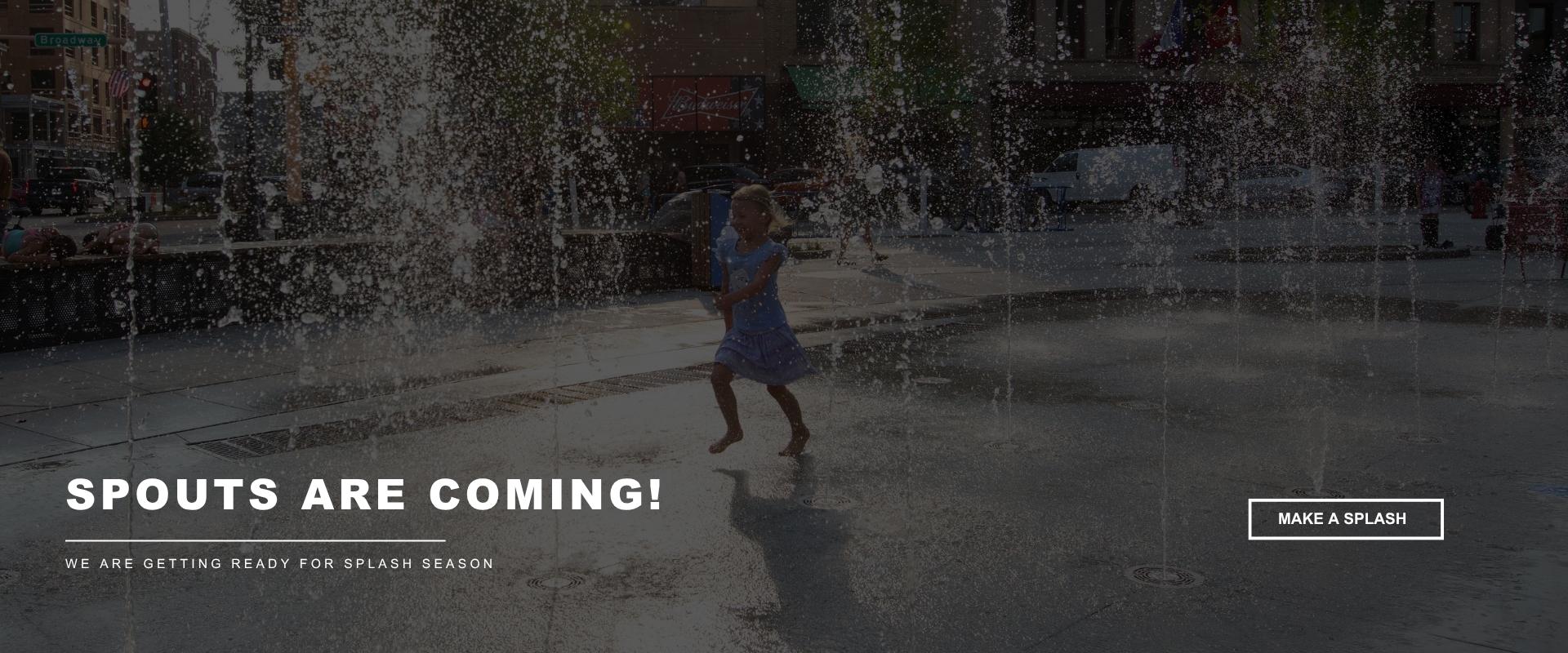 Young child runs through water fountains at an outdoor splash pad in downtown Fargo. Text reads “Spouts Are Coming!” and “We are getting ready for splash season.”