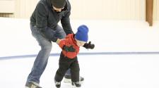 This image shows a father and son ice skating