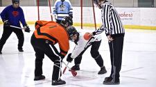 This image shows the faceoff during adult broomball.