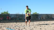 This image shows a male volleyball player serving. 