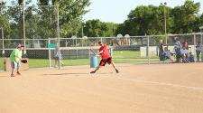 This image shows a male batting during the adaptive softball program.