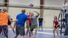 This image shows a male volleyball player setting up a serve. 