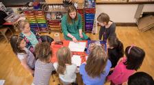 This image shows the instuctor showing kids what to do during the art class.