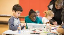 This image shows a boy and girl working on their projects during an art class.