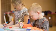 This image shows two kids coloring at Awesome Art Afternoon.