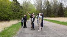This image shows a group of people using binoculars during the birding program.