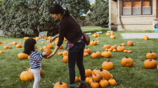 This image shows a mom and daughter picking out a pumpkin at Fall in Fargo.