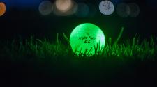 This image shows a glow ball in the grass at Glow Golf.