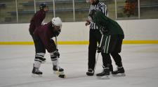 This image shows a face off at the adult hockey league.