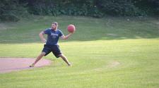This image shows a male throwing the kickball during kickball league.