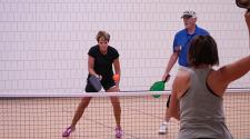 This image shows a pickleball game at the North Dakota Senior Games.