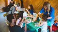 This image shows a table indoors of kids learning how to make a project from the instructors at Park It.