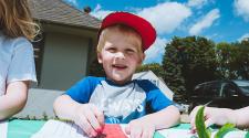 This image shows a young boy coloring outdoors during Park It.