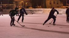This image shows a people playing hockey during S'mores and More.