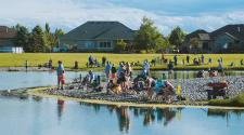 This image shows all the participants around the pond at Trout Fest.