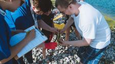 This image shows a boy's fish getting measured during Trout Fest.