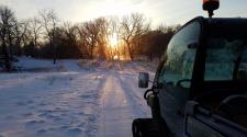 This image shows a cross country ski trail getting groomed.