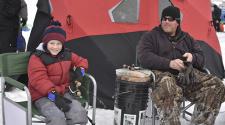 This image shows a dad and his son at the Youth Ice Fishing Derby.