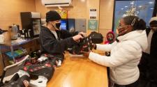 This image shows a female renting skates from the Skate Shack at Broadway Square.