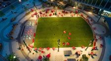This image shows an aerial view of Broadway Square on a summer night.