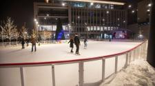 This image shows people skating on SCHEELS Skating Rink at Broadway Square during a Rink Reels movie event.