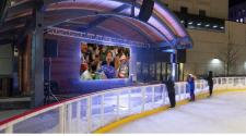 This image shows three young kids standing on SCHEELS Skating Rink watching a movie during the Rink Reels event.