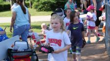 kids walking off the baseball field with their gloves in hand