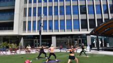 People doing Yoga at Broadway Square