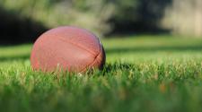 Football sitting in grass 