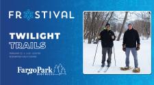 Frostival logo on blue background  - TWILIGHT TRAILS - February 22 - 6-8pm - Edgewood Golf Course with the Fargo Park District  logos - to the left is an image of Two men stand smiling in the winter wilderness both dressed in warm winter gear. One man is in cross country skis and poles, the other man is using snow shoes. 