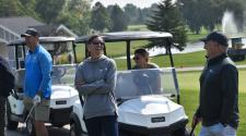 a group of people in golf carts