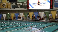 This image shows a swimmer competing in a lane during an indoor swimming event at the North Dakota Senior Games.
