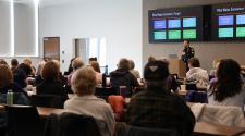 Police gives a talk to a conference room full of adults. 