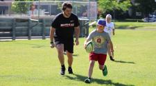This image shows the recreation intern teaching rugby.